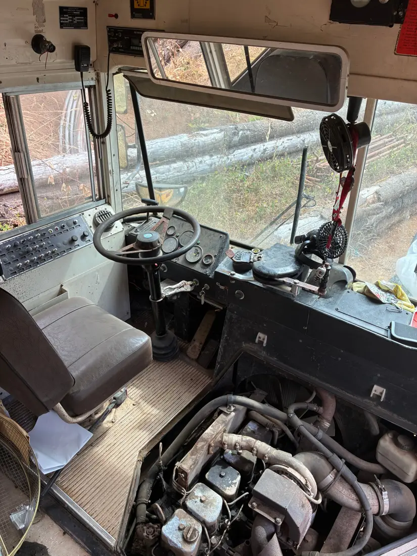 The driver seat, steering wheel and exposed engine