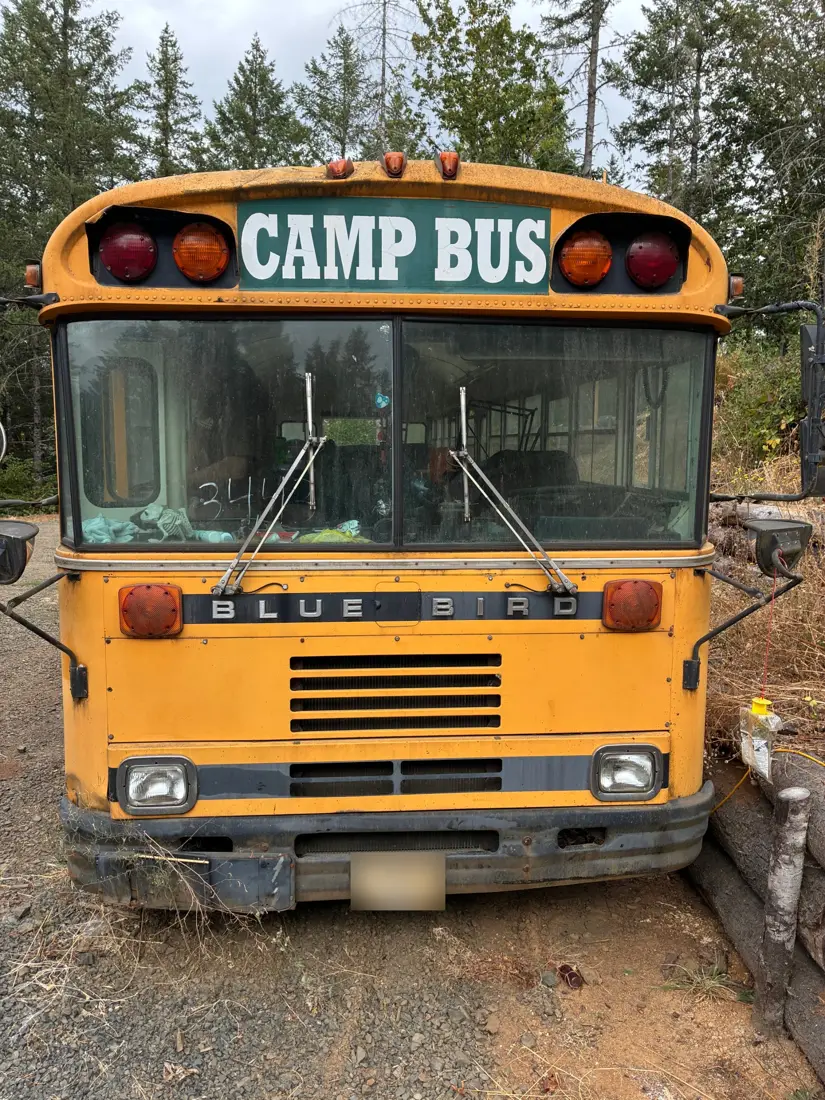 Front of the bus with the hood grille and headlights